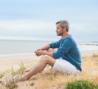 Man at beach healing from therapeutic mental health services